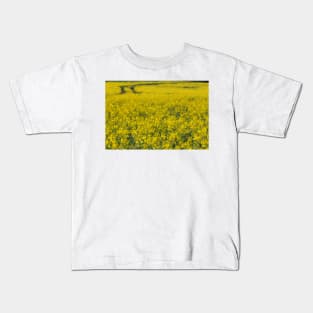 agricultural field full of bright yellow flowering crop of oil seed Kids T-Shirt